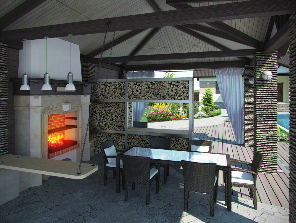 View inside a modern outdoor kitchen with roof and wood fired oven.